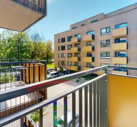View from the balcony on Sadová Street in Senica, panel apartment next to greenery.
