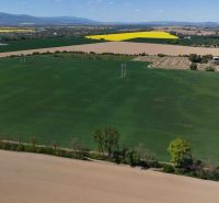 Aerial view of green fields surrounded by agricultural landscape near Trhovište.