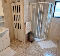 A bathroom in a family house with a shower and tiles, a cozy space solution.