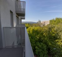 Balcony with a view of greenery and buildings in Bratislava, Ivanská cesta, 2-room apartment.