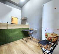 Gastro premises with a counter, stools, and a wooden decor floor.