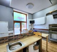 Interior of gastro spaces with kitchen equipment and flooring with wood decor.