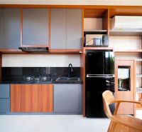 A kitchen in a villa with wooden decor, equipped with modern appliances and storage space.