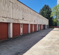 A row of garages on Hanulova Street in Bratislava - Dúbravka, lined with trees.