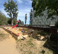 Playground in Bratislava - Petržalka with a sandbox and a slide near the apartment building.