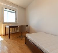 A room with a bed, a table, and a floor with a wooden decor in a 4-room apartment.