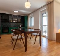 Dining area with wood-patterned flooring and a view in a 4-room apartment.