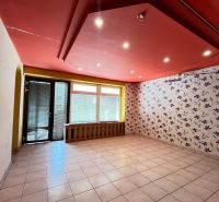 Commercial space with a red ceiling, tiled floor, and floral wallpaper.