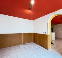 Interior of commercial premises with a red ceiling, white walls, and tiles.