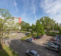View of the parking lot and greenery on Exnárova Street in Bratislava - Ružinov.