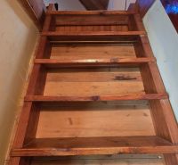 Wooden stairs and ceiling with wooden decor in the cottage.