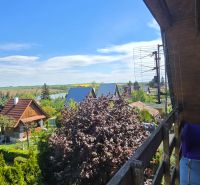 The view from the cottage in Suchá nad Parnou, Nové Vinohrady, over the green gardens and roofs.