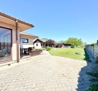 A family house on Močenská Street in Cabaj-Čápor with a garden and a paved courtyard.