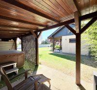 Wooden gazebo with a hot tub in the garden of a family house on Močenská Street in Cabaj-Čápor.