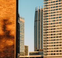 High-rise buildings with glass facades in Bratislava - Ružinov at sunset.
