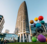Construction of apartments on Pribinova Street in Bratislava - Ružinov with a colorful sculpture in the foreground.