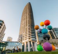 In Bratislava on Pribinova Street, there is a tall building with a colorful sculpture.