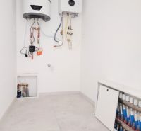 Boiler room in a family house with an installed boiler and water heater.