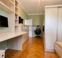 A study in a 3-room apartment with shelves, a desk, and a floor with a wood decor.