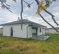 A family house in Topoľnica with a garden and terrace, surrounded by a decorative fence.