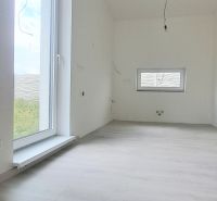Interior of a family house with a wooden decor floor and a large window.