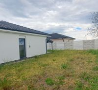 A family house in Topoľnica with a white facade, garden, and fence.