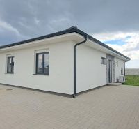 A family house in Topoľnica with a white facade and a paved courtyard.