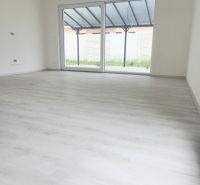 Interior of a family house with a large window and a wooden decor floor.