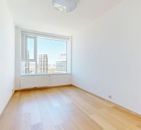 A room in a 4-room apartment with a window and a floor with a wooden decor.