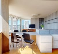 Living room in a 4-room apartment with a wooden decor floor and a view of the city.