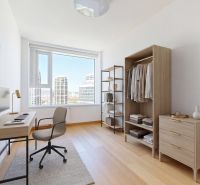 A study in a 4-room apartment with a floor featuring a wood decor and furniture made of wood.