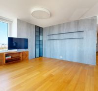 Living room in a 4-room apartment with a wooden decor floor and a large window.