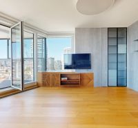 A bright room with a wooden decor floor and a view from a 4-room apartment.