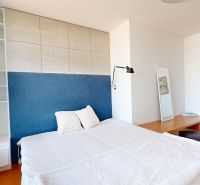 Bedroom in a 4-room apartment with a bed and furniture, floor with wooden decor.