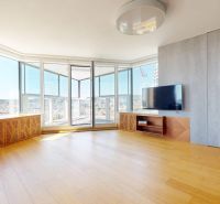 Living room with large windows and wood-patterned flooring in a 4-room apartment.