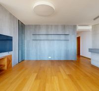 Living room with built-in furniture and wood-patterned flooring in a 4-room apartment.