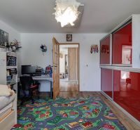 Children's room in a family house with a colorful carpet and a desk.