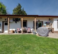 A family house in Potzneusiedl with a lawn, terrace, and outdoor seating.