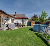Family house in Potzneusiedl with a pool and a terrace in a sunny yard.