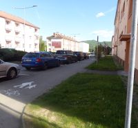 Parking lot and buildings by the road in Žiar nad Hronom near a 2-room apartment.