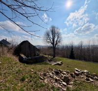 Residential plots in Lubina capture the natural landscape with an old building and trees.