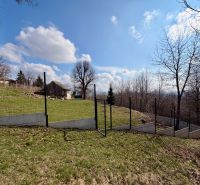 The residential plots in Lubina offer a view of the picturesque countryside with a fence.