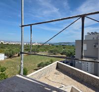 The view from the 3-room apartment in TRIBUNJ shows a construction site and a panorama with the sea.