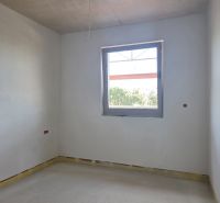 An empty room with a window in a 3-room apartment ready for further modifications.