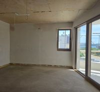 Interior of a 3-room apartment with a balcony and a view of the countryside.