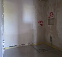 Interior of a 3-room apartment with wall plastering and marked locations for installations.