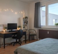 Bedroom with a desk, computer, chair, and shelf in a four-room apartment. Floor with wood decor.
