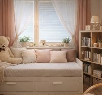 A place to relax in a 4-room apartment with a plush bear and a shelf full of books.