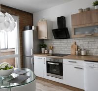 A bright kitchen with appliances, a dining table, and a wooden decor floor in a 4-room apartment.