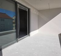 A balcony of a 3-room apartment in the city of Srima with access through large sliding doors.